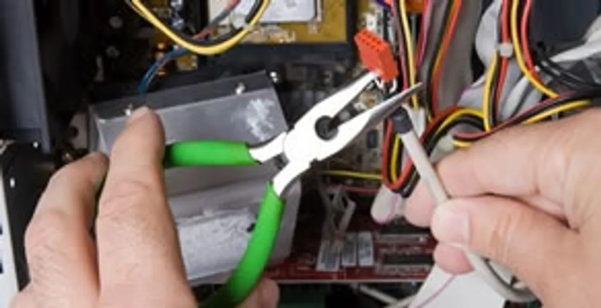 Licensed electrical contractor performing electrical repair with tools in Byron Center, MI